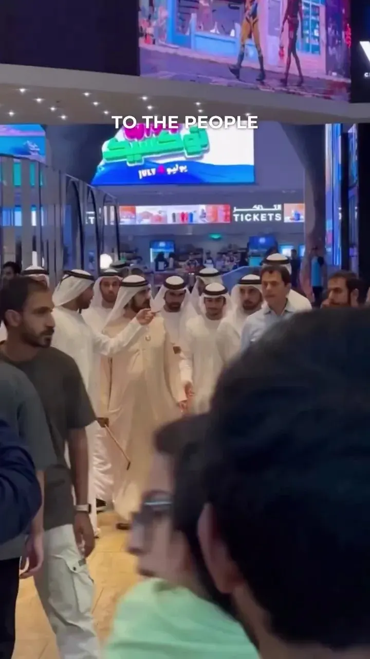 Men in traditional Emirati dress walking through a busy indoor public area in Dubai Men in traditional Emirati dress walking through a busy indoor public area in Dubai