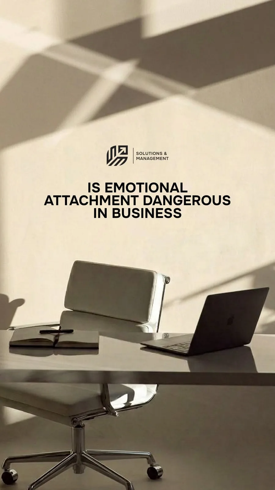 Office desk with laptop and text saying ‘Is emotional attachment dangerous in business’ by Solutions & Management