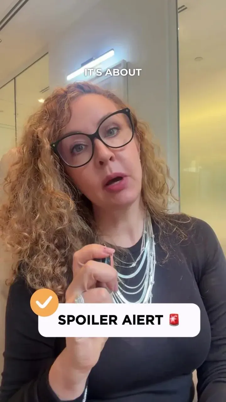 Professional woman with glasses in an office setting, used as a generic visual for DIFC holding company setup content