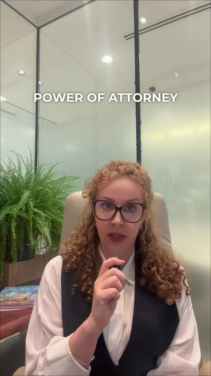 Professional woman in an office with the words POWER OF ATTORNEY in the foreground, representing UAE powers of attorney and related legal matters